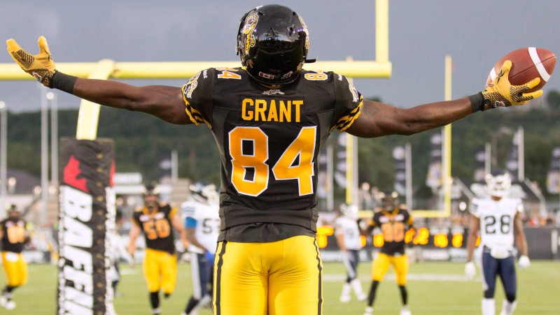 Receiver Bakari Grant celebrates a touchdown as a member of the 2015 Hamilton Tiger-Cats (Photo by Canadian Press/Peter Power)