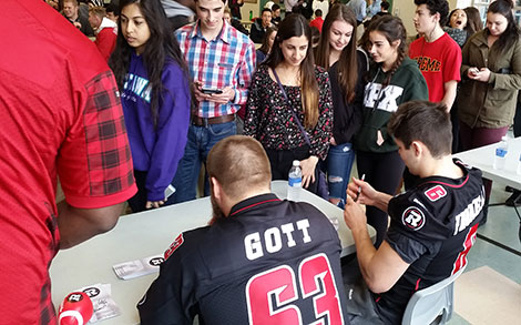 Jon Gott and Antoine Pruneau signing autographs during a Lunch Bunch session