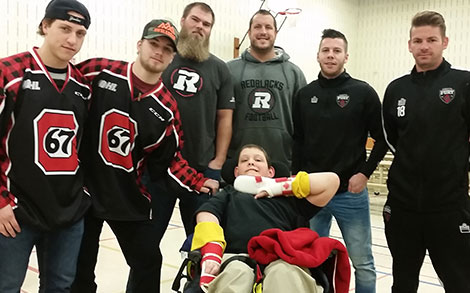 Dante Salituro, Travis Barron, Jon Gott, Alex Mateas, Carl Haworth and Brandon Poltronieri posing with a student during a Lunch Bunch session